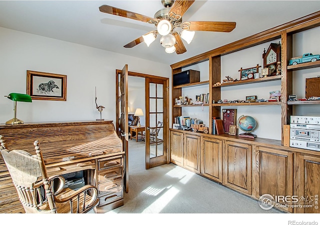 carpeted home office featuring ceiling fan and french doors