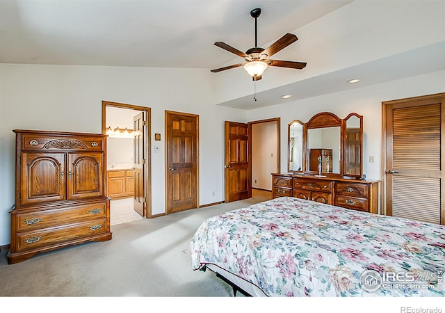 carpeted bedroom featuring ensuite bathroom, ceiling fan, and lofted ceiling