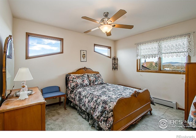 bedroom featuring baseboard heating, ceiling fan, and light colored carpet