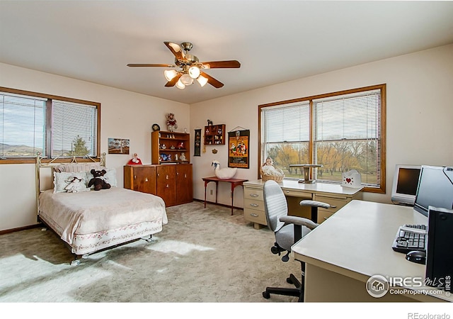 carpeted bedroom with multiple windows and ceiling fan