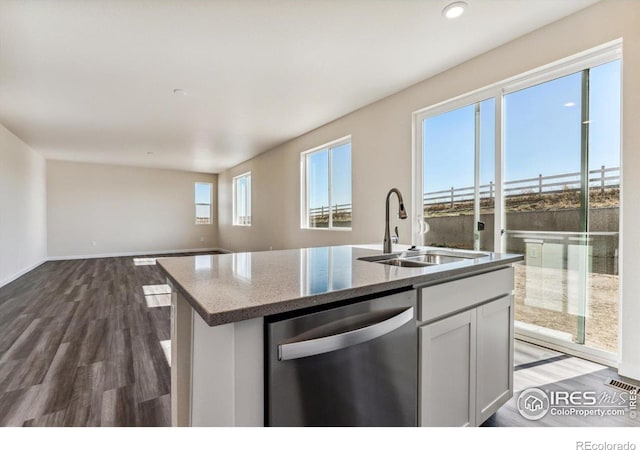 kitchen with dishwasher, dark hardwood / wood-style floors, a wealth of natural light, and sink