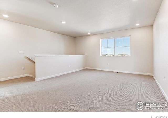 spare room with light colored carpet