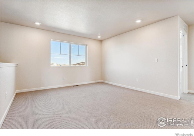 unfurnished room with light colored carpet