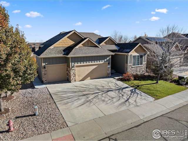 view of front of home featuring a garage and a front lawn