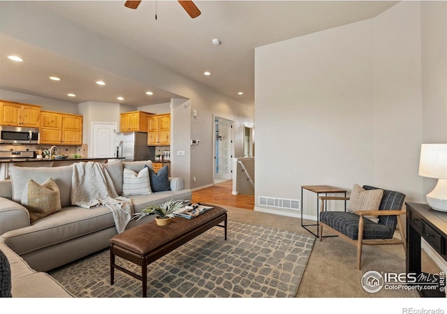 living room featuring ceiling fan and sink