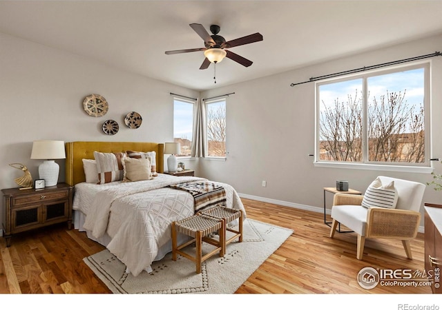 bedroom with ceiling fan and hardwood / wood-style floors