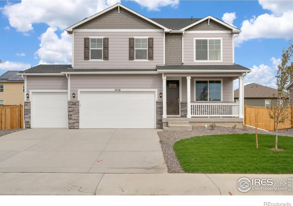 craftsman-style house with covered porch, a front yard, and a garage