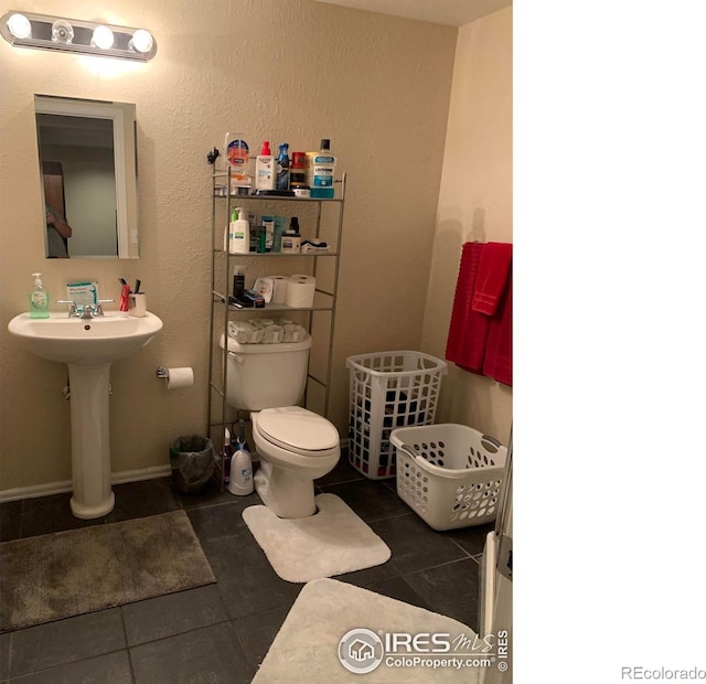 bathroom with tile patterned flooring and toilet