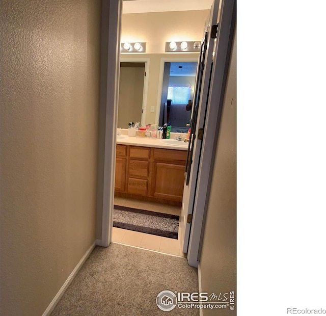 bathroom with tile patterned flooring and vanity