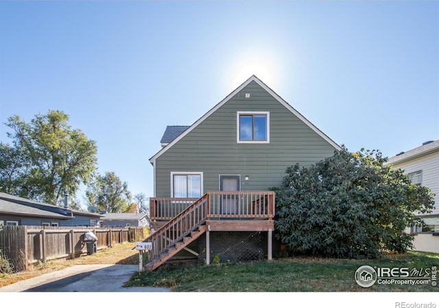 rear view of house featuring a deck