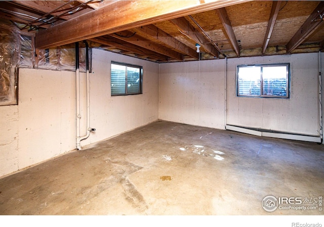 basement featuring a baseboard heating unit