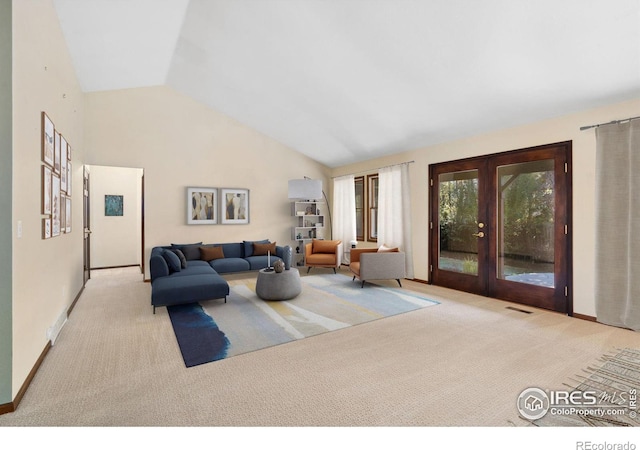 living room featuring lofted ceiling, light carpet, and french doors