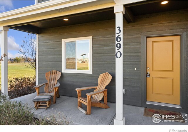 view of exterior entry with covered porch