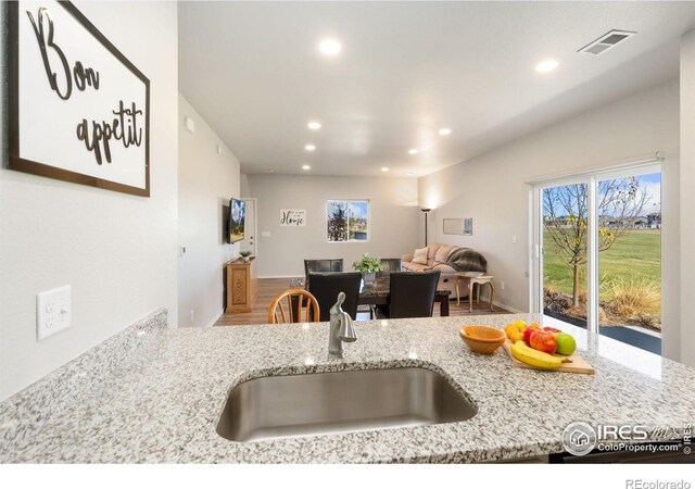 kitchen with light stone counters and sink