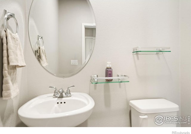 bathroom with toilet and sink