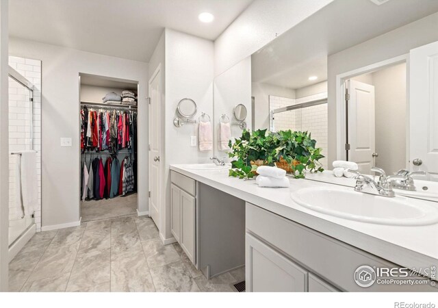 bathroom featuring vanity and an enclosed shower