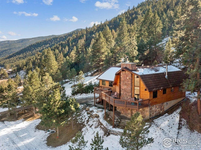 snowy aerial view featuring a mountain view