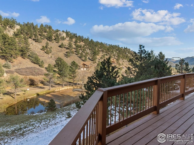 deck with a water and mountain view