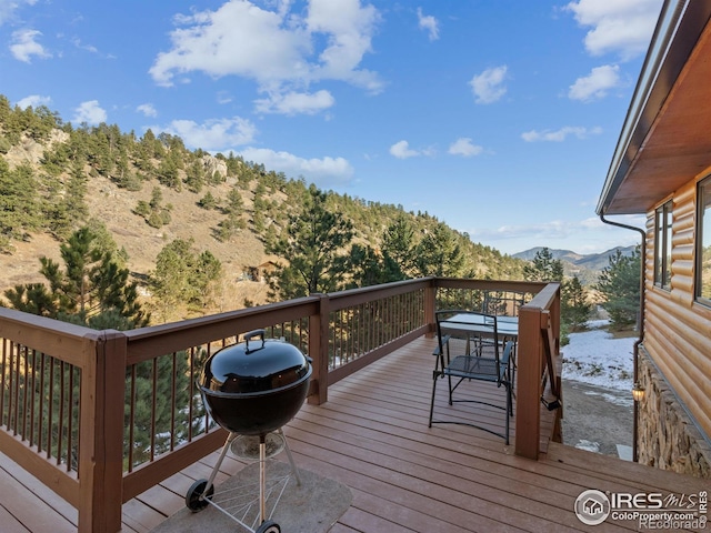 wooden deck featuring a grill and a mountain view