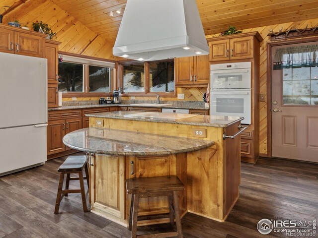 kitchen featuring island exhaust hood, white appliances, vaulted ceiling, wooden ceiling, and a center island