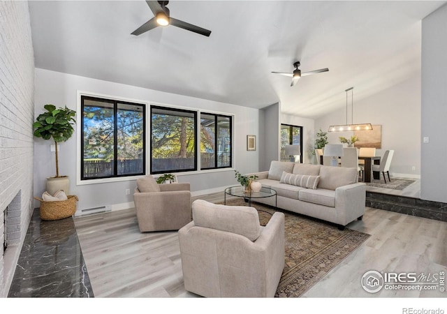 living room with baseboard heating, light hardwood / wood-style flooring, vaulted ceiling, and ceiling fan