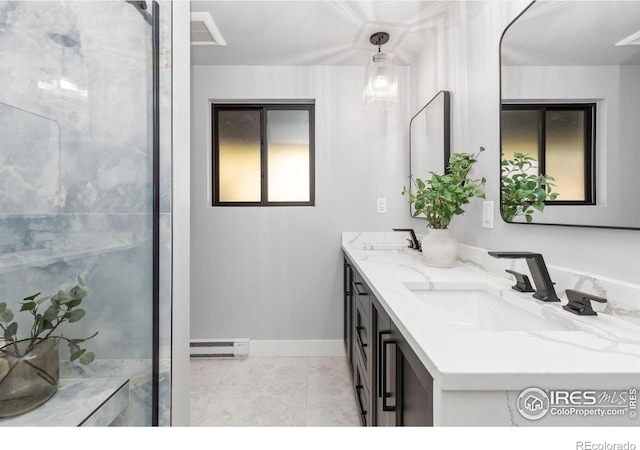 bathroom with tile patterned floors, vanity, and a baseboard heating unit