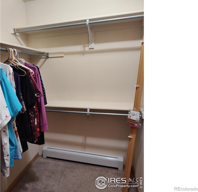 walk in closet featuring carpet flooring and baseboard heating