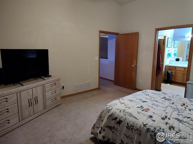 carpeted bedroom featuring ensuite bath