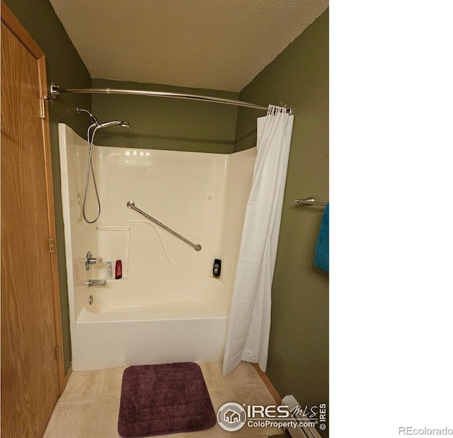 bathroom featuring a textured ceiling and tile patterned floors