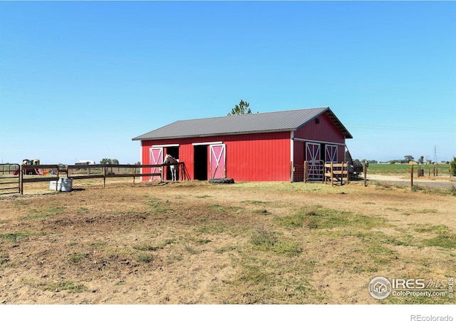 view of outbuilding featuring a rural view