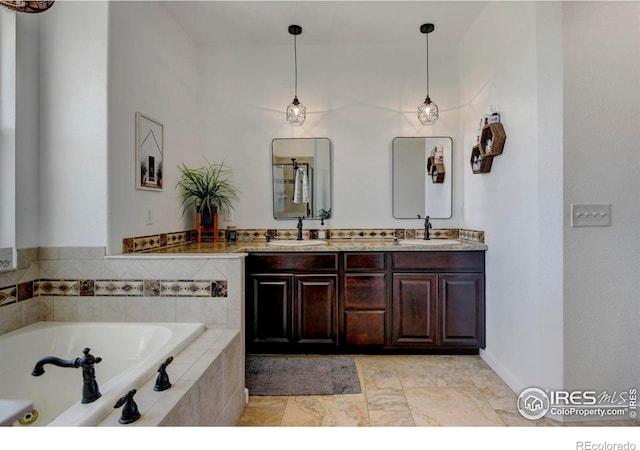 bathroom with a relaxing tiled tub and vanity