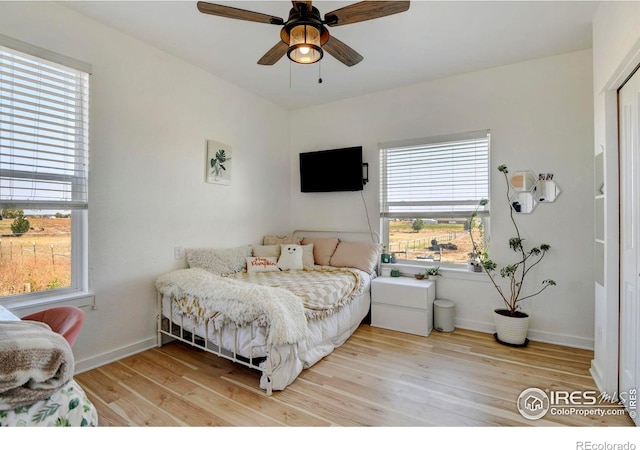 bedroom featuring light wood-type flooring and ceiling fan