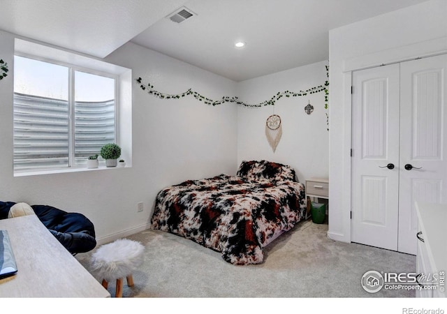 carpeted bedroom featuring a closet