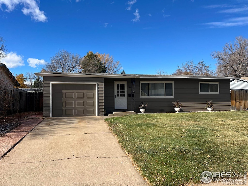 single story home with a garage and a front lawn