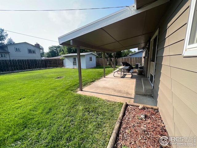 view of yard with an outdoor structure and a patio area