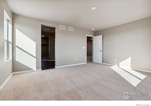 unfurnished room with light colored carpet