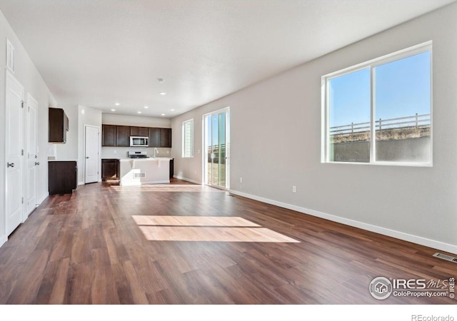 unfurnished living room featuring dark wood-type flooring