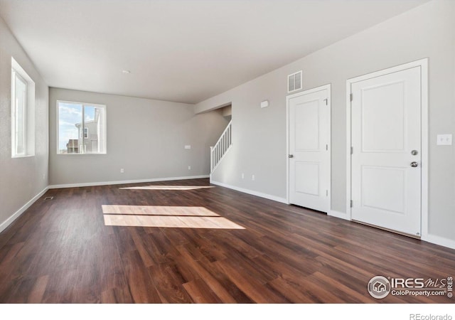 spare room with dark hardwood / wood-style floors