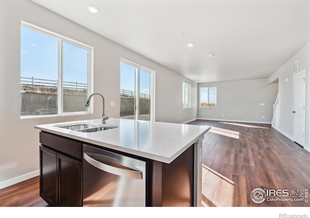 kitchen featuring stainless steel dishwasher, dark hardwood / wood-style flooring, sink, and a center island with sink