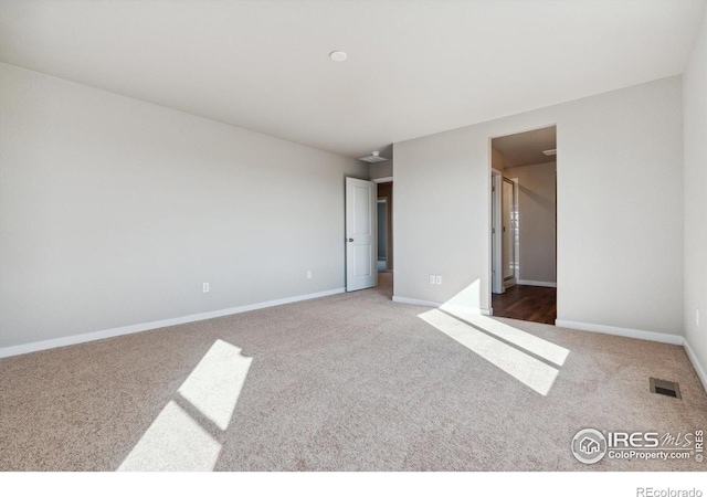 unfurnished bedroom featuring ensuite bath and carpet