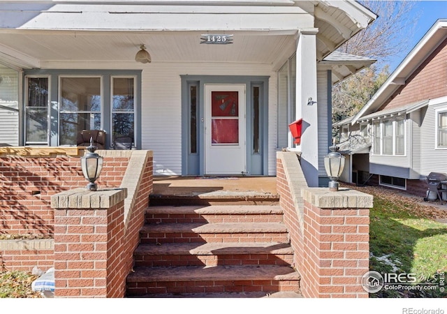 view of exterior entry with a porch