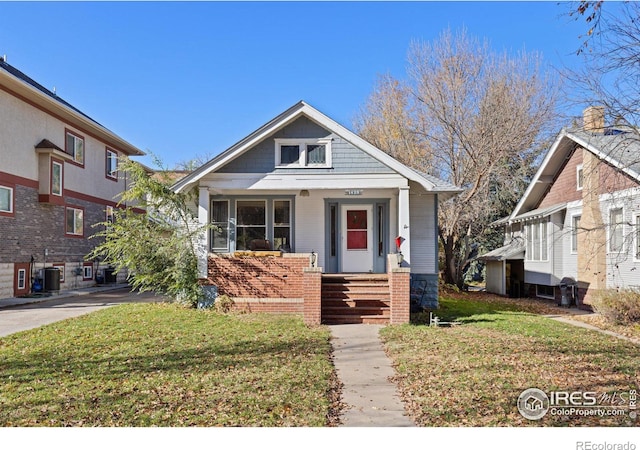 bungalow-style home with a front lawn