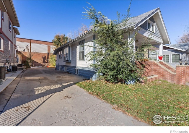 view of side of property featuring central AC