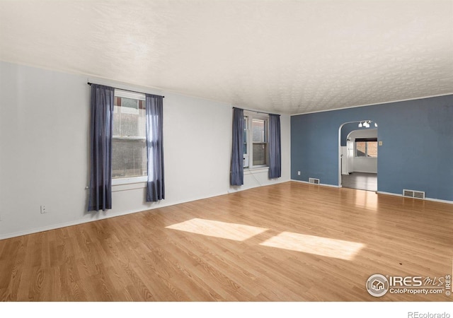 spare room with hardwood / wood-style floors and a textured ceiling