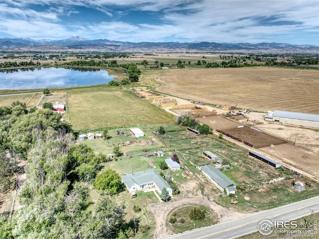 aerial view featuring a rural view and a water and mountain view