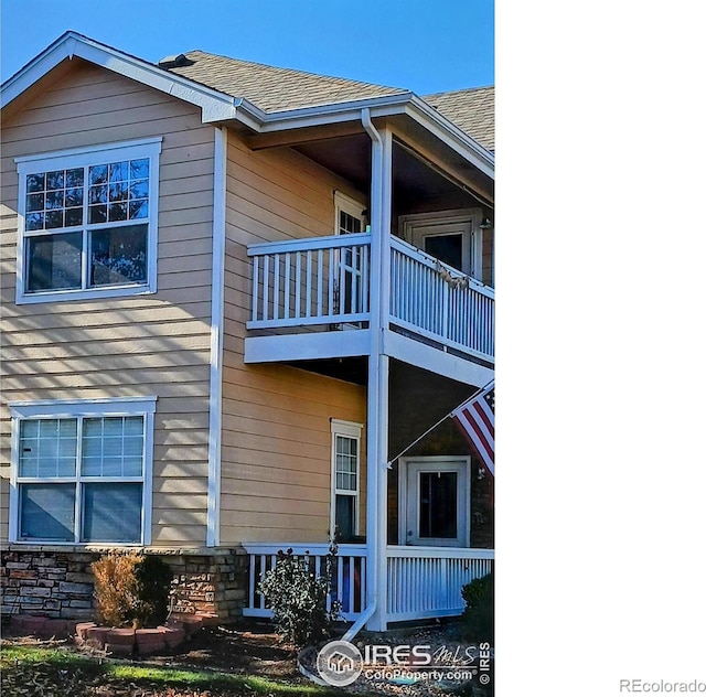 view of side of home featuring a balcony