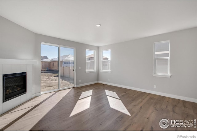 unfurnished living room featuring a fireplace and light hardwood / wood-style flooring