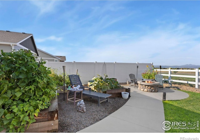 view of patio / terrace featuring an outdoor fire pit