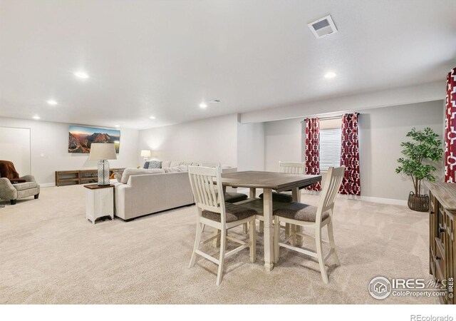 dining space featuring recessed lighting, light colored carpet, visible vents, and baseboards