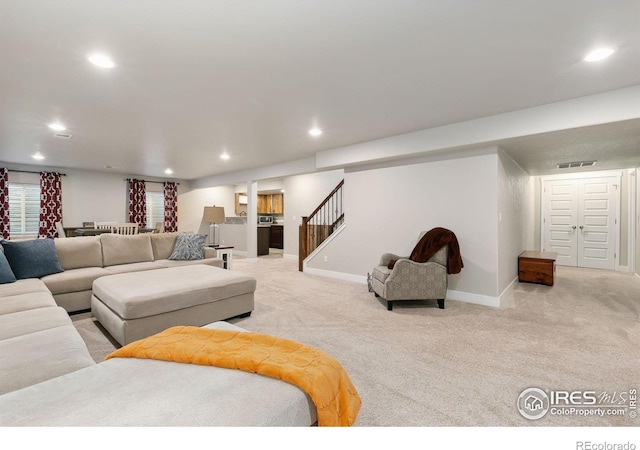 living room featuring light carpet, stairway, visible vents, and recessed lighting